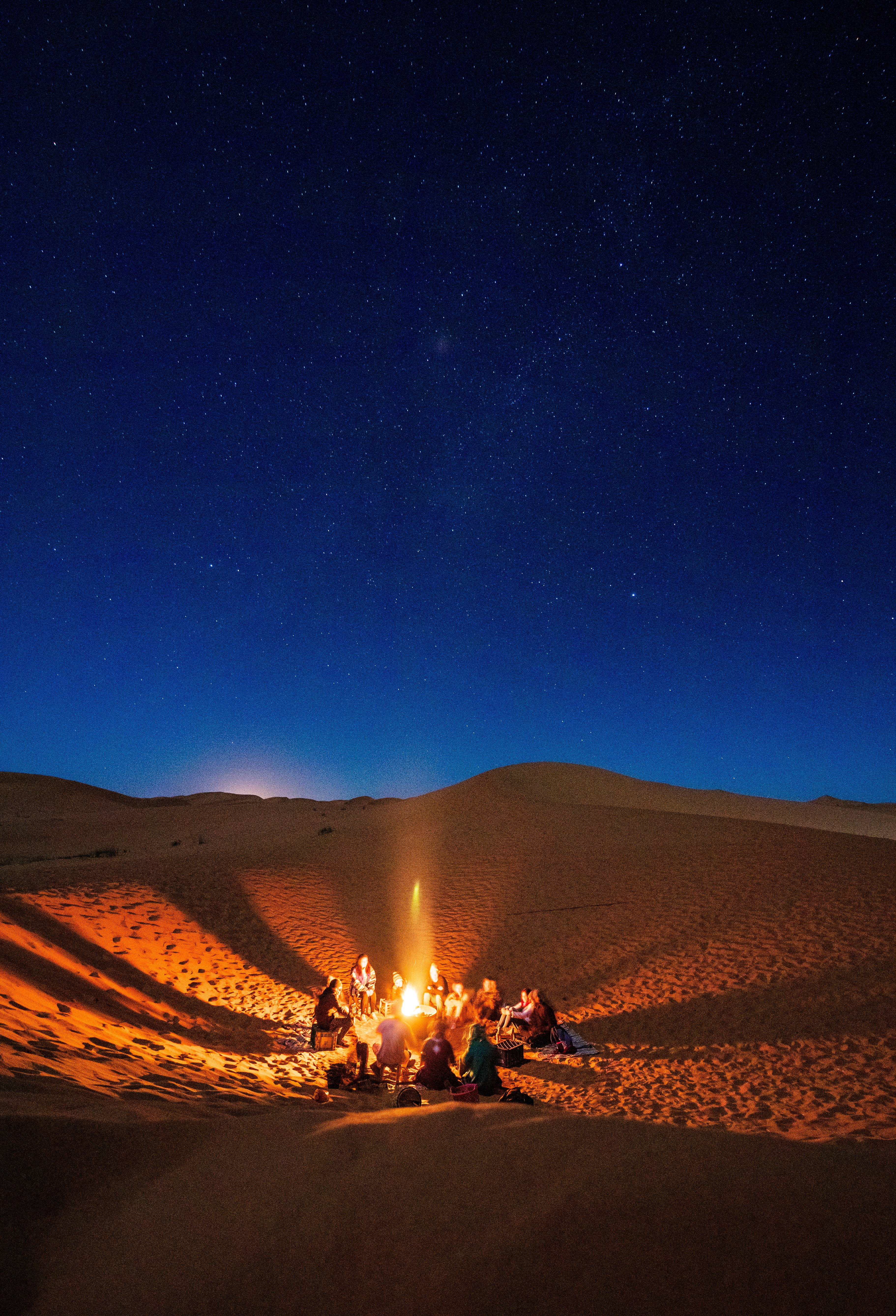 Friends responsibly enjoying a camp fire in the desert